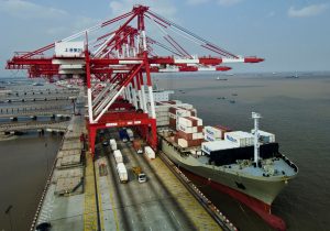 Red and white cranes and Matson ship at Zhendong Container Terminal, Shanghai International Port