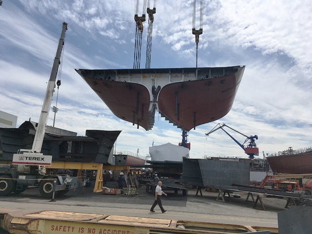 DKI's stern is carefully lowered into position.