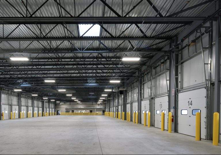 An empty interior of a thirty door cross-dock facility is ready for use.