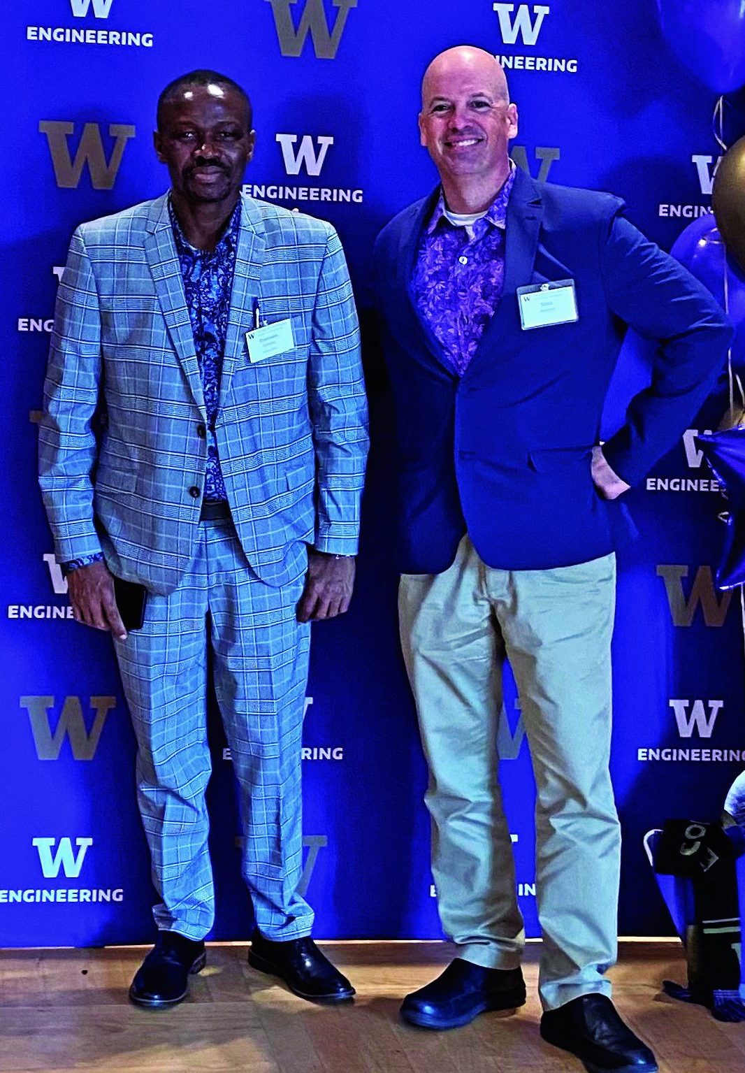 A Matson Leadership Diversity Scholar stands with a Matson Ambassador in front of a Univeristy of Washington Engineering step and repeat.